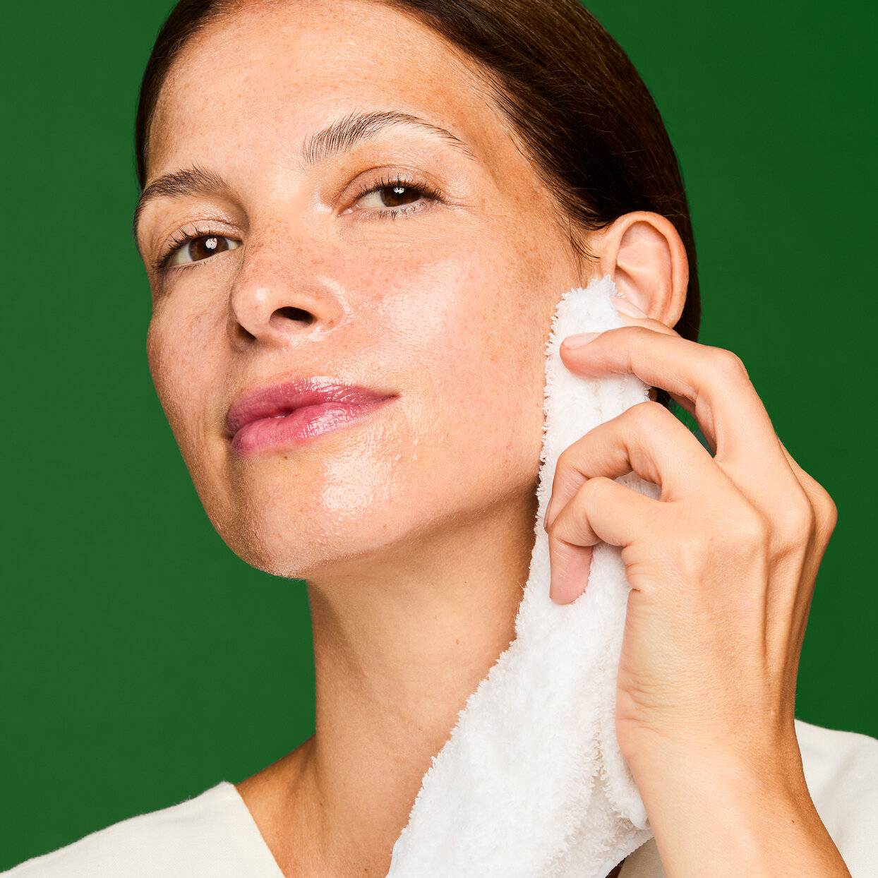 Superskin™ Advanced Nourishing Cleansing Balm 100ml woman removing cleanser with a reusable cotton cloth
