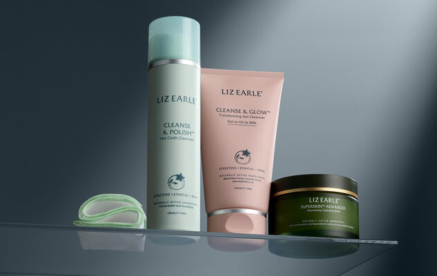 Cleanse & Polish™ Hot Cloth Cleanser 100ml, Cleanse & Glow™ Transforming Gel Cleanser 150ml, and Superskin™ Advanced Nourishing Cleansing Balm 100ml sat on a glass shelf against a dark grey background