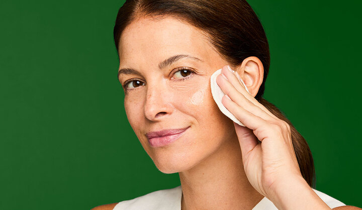 a woman applying an eye cream
