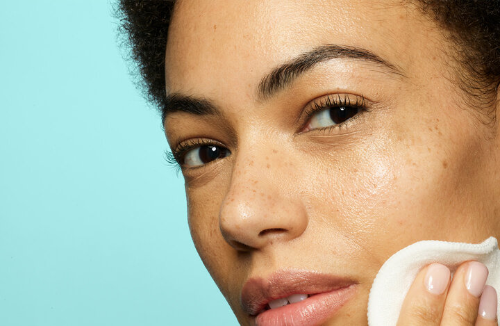 A woman using skincare products
