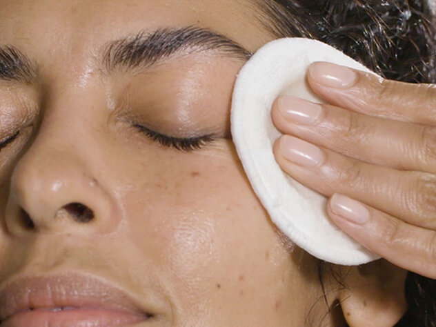 a woman using an eye cleanser
