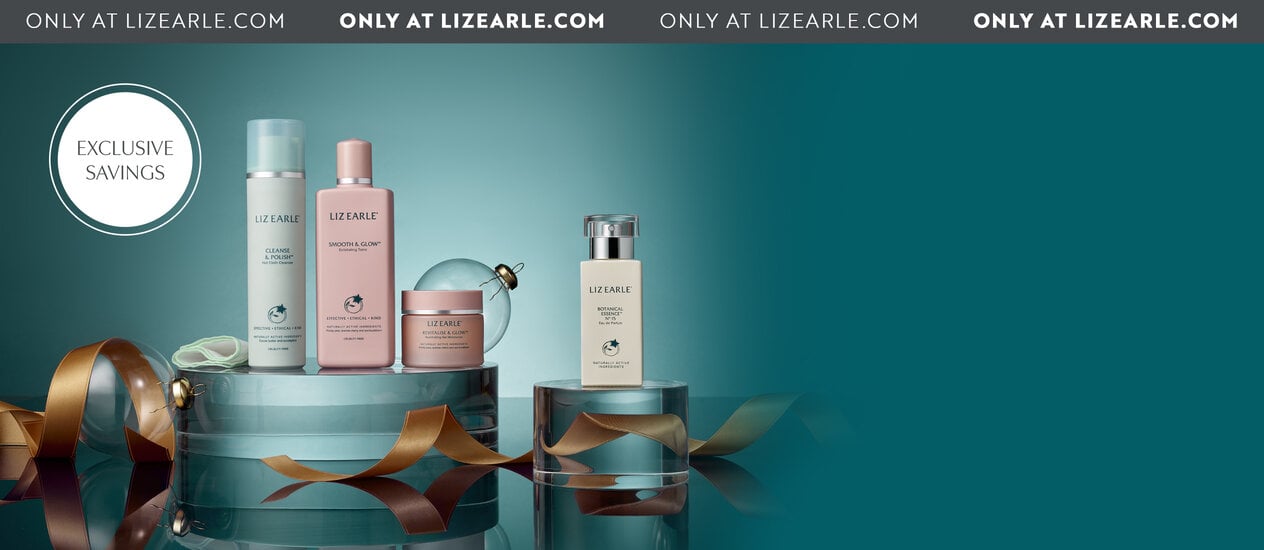 Cleanse & Polish™ Hot Cloth Cleanser 100ml, Smooth & Glow™ Exfoliating Tonic 200ml, Revitalise & Glow™ Illuminating Gel Moisturiser 50ml and Botanical Essence™ No.15 Eau de Parfum 50ml sat on glass plinths. with curled gold ribbon in front and a blue background.