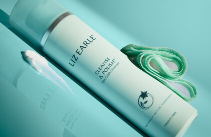 Liz Earle Cleanse and Polish laid on its side on a blue background