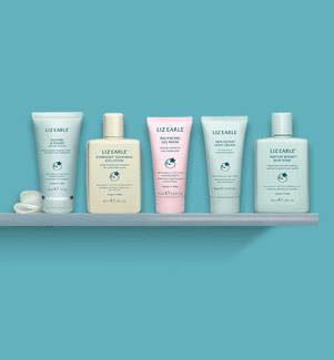 Liz Earle Beauty Co. travel size skincare products on a blue background